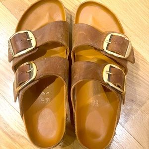 Tan Birkenstocks with unique gold-toned buckles. Hard to find!